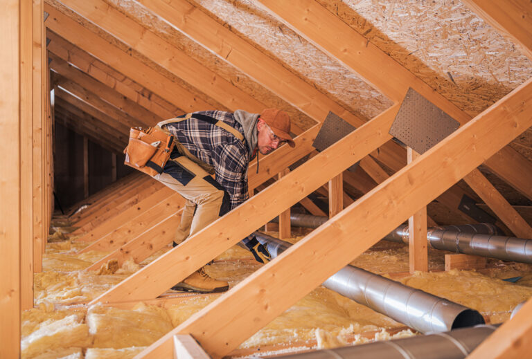 Image of man insulating a roof for efficiency - Energy Security Strategy